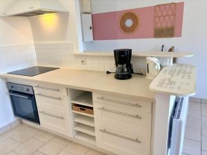 a kitchen with a sink and a counter top at Maison avec jardin in Harquency +7 photos