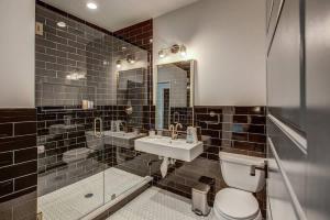 a bathroom with a sink and a toilet and a mirror at Chic Tennyson St Retreat - Walk to Shops & Cafes in Denver