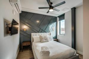 a bedroom with a white bed and a ceiling fan at Chic Tennyson St Retreat - Walk to Shops & Cafes in Denver