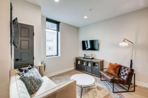 a living room with a couch and a table at Chic Tennyson St Retreat - Walk to Shops & Cafes in Denver +3 photos