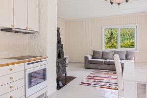 a kitchen and a living room with a couch at Lobrothaugen in Fagernes