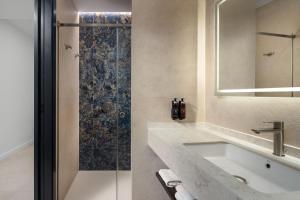 a bathroom with a sink and a shower at AZUL HOME SUITES Estepona in Estepona