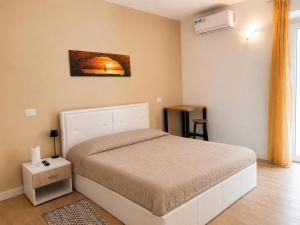 a bedroom with a bed in a room at Riviera AlbaChiara B&b in Anzio