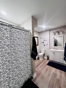 a bathroom with a black and white patterned wall at Cozy Hideaway guest suite in Midlothian