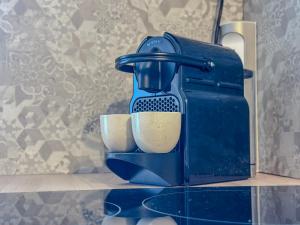 a blue coffee maker with two cups on a counter at Le Charles - Gare - CEA - STMicro in Fontaine