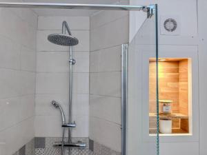a shower with a glass door in a bathroom at Le Charles - Gare - CEA - STMicro in Fontaine +23 photos