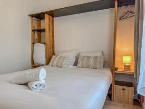 a bedroom with two bunk beds with white sheets at Le Charles - Gare - CEA - STMicro in Fontaine