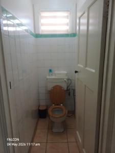 a bathroom with a toilet with a wooden seat at Oranje Air B&B in Alexander Bay
