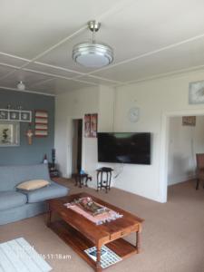 a living room with a couch and a coffee table at Oranje Air B&B in Alexander Bay