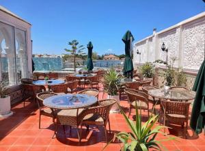 a patio with tables and chairs on a balcony at Dar Lala Fatma in Le Lido