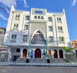 a white building with a sign on it at Dar Lala Fatma in Le Lido +5 photos