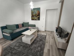 a living room with a couch and a table at N&L apartments in Strumica +5 photos