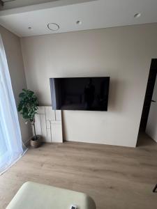 a living room with a flat screen tv on a wall at Locusdo apartment Nr 27 in Vilnius