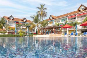 a pool at a resort with chairs and umbrellas at Decameron Isleño - All Inclusive in San Andrés
