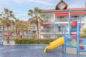 a pool with a slide in front of a hotel at Decameron Isleño - All Inclusive in San Andrés
