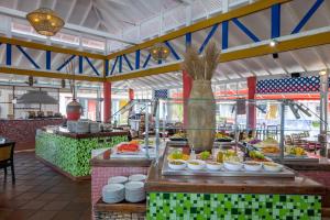 a buffet line with plates of food in a restaurant at Decameron San Luis - All Inclusive in San Andrés +13 photos