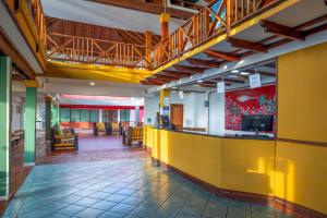 a lobby with a yellow counter in a building at Decameron San Luis - All Inclusive in San Andrés