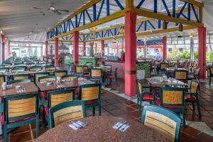 an empty restaurant with tables and chairs in it at Decameron San Luis - All Inclusive in San Andrés