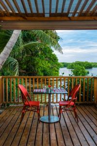 a table and two chairs on a deck at Decameron Marazul - All Inclusive in San Andrés