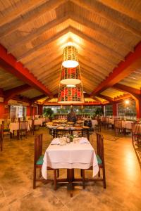 a dining room with tables and a chandelier at Decameron Marazul - All Inclusive in San Andrés +12 photos