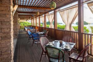 a restaurant with tables and chairs on a deck at Decameron Marazul - All Inclusive in San Andrés