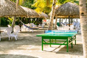 a ping pong table and chairs on a beach at Decameron Galeon - All Inclusive in Santa Marta