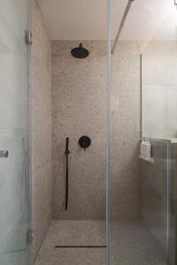 a shower with a glass door in a bathroom at JIRONI VILLA in Nikiti
