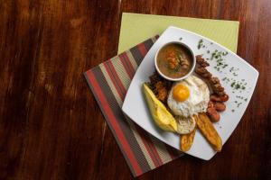 a plate of breakfast food with an egg and beans at Decameron Panaca - All Inclusive in Quimbaya
