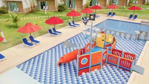 an overhead view of a swimming pool with chairs and umbrellas at Decameron Barú - All Inclusive in Playa Blanca