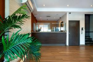 a hallway with a reception desk and a plant at Hotel Newstar Montréal in Montreal