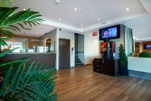 a lobby with a television in a building at Hotel Newstar Montréal in Montreal