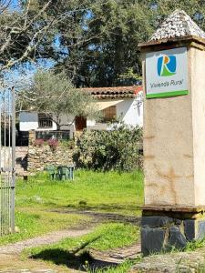 a sign on a stone pillar in front of a yard at Casa Papiqui in Fuenteheridos