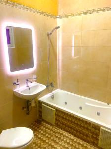 a bathroom with a sink and a tub and a toilet at Riad Nezha avec piscines jacuzzi parking à quelques minutes à pied du centre-ville in Marrakesh +47 photos