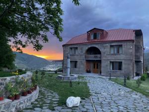 a large stone building with a red roof at NOV Lernatun Boutique Hotel in Ltsen