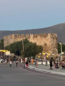 a group of people walking down a street in front of a castle at Central House Karistos Two in Karistos