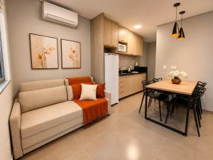 a living room with a couch and a table at Yolanda Flats in Foz do Iguaçu