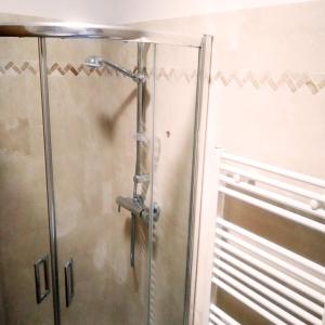 a shower with a glass door in a bathroom at Residenza Alice 2 - Toscana mare e monti in Camaiore +16 photos