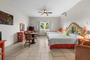a bedroom with two beds and a table and chairs at Marina Banderas Suites Hotel Boutique in Nuevo Vallarta +98 photos