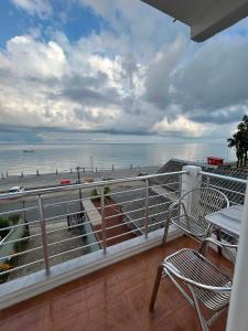 a balcony with a view of the beach and the ocean at Hotel Lika in Batumi