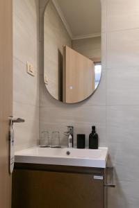a bathroom with a white sink and a mirror at Terra rossa rooms in Čepljani