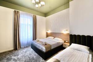 a hotel room with two beds and a window at BOUL ROSU RESIDENCE free private parking in Arad