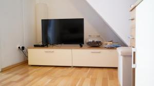 a television sitting on a dresser in a living room at Apartmani Vela Luka in Vela Luka