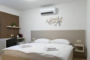 a bedroom with a bed with two towels on it at Terra rossa rooms in Čepljani