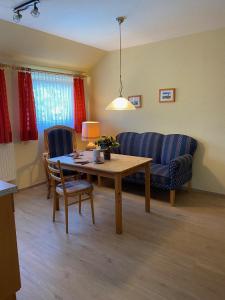 a living room with a table and a couch at Nordsee 405 in Wangerooge