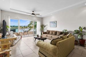 a living room with two couches and a table at Marina Banderas Suites Hotel Boutique in Nuevo Vallarta