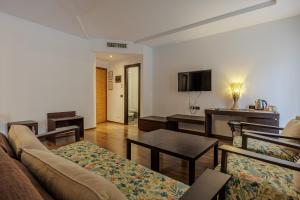 a living room with a couch and a table at Hotel alla Grotta in Lazise