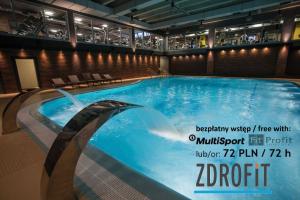 a large swimming pool in a building at No̱410 City View Apartment & free parking in Krakow