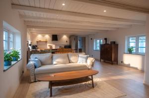 a living room with a couch and a table at Almeboda in Österlen in Östra Hoby