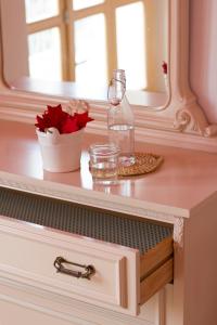 a dresser with a glass bottle on top of it at Arcobaleno B&B in San Benedetto del Tronto