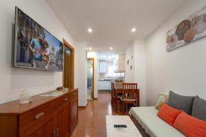 a living room with a couch and a dining room at Apartamento By Llu in Alcalá la Real